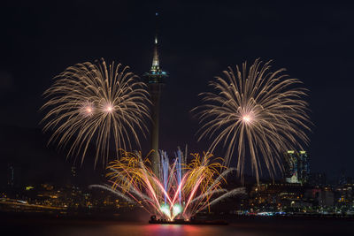 Firework display in city at night