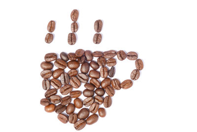 Directly above shot of coffee beans against white background