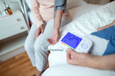 High angle view of people sitting on bed