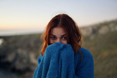 Portrait of beautiful woman against sky during sunset