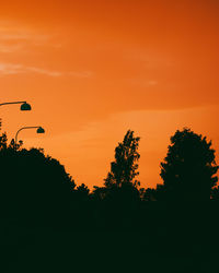 Silhouette trees against sky during sunset