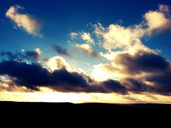 Scenic view of landscape against cloudy sky