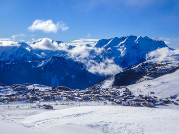 Scenic view of snowcapped mountains against sky