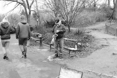 People walking by trees