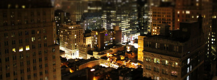 High angle view of city lit up at night