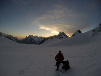 Rear view of man riding horse in snow
