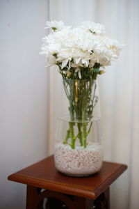 Close-up of white flower vase on table at home