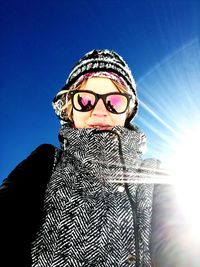 Low angle view of woman against blue sky