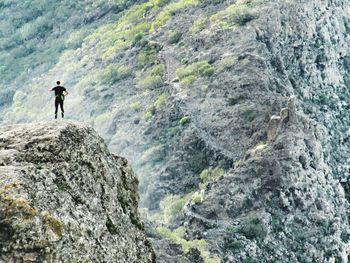 High angle view of man climbing on rock
