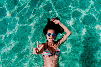 High angle view of a smiling young man swimming pool