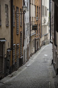 Alley amidst street in city