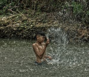 High angle view of shirtless man in water