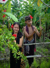 A girl and boy is feeling happy to take care the plants