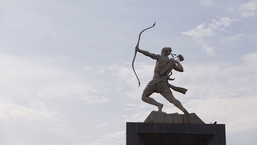 Low angle view of statue against sky