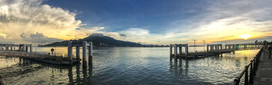 Pier over sea against sky during sunset