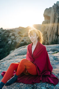 Woman sitting on rock