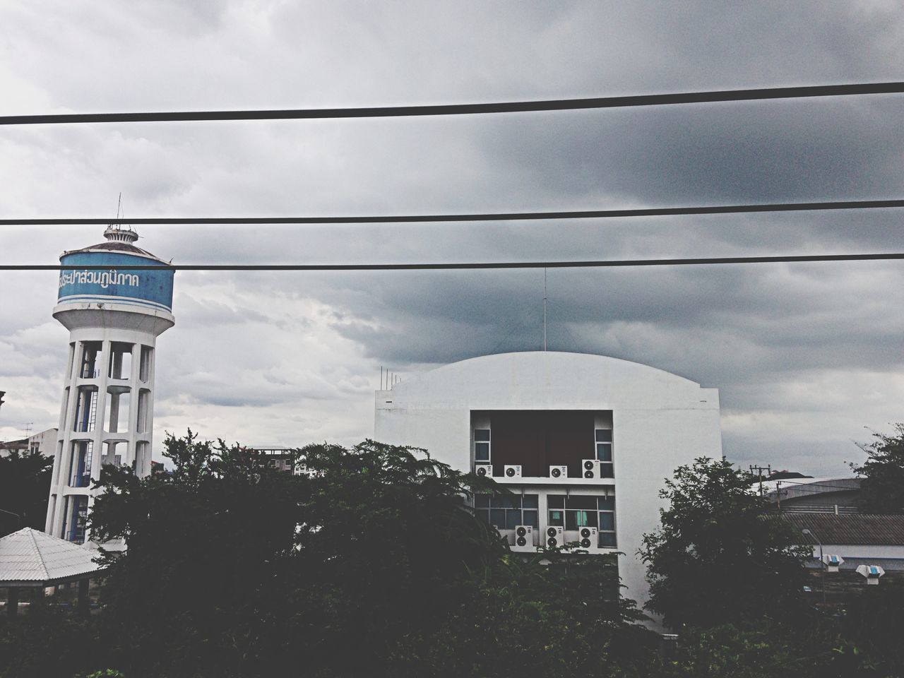 architecture, building exterior, built structure, sky, cloud - sky, low angle view, cloudy, cloud, house, power line, residential structure, street light, residential building, tree, building, cable, day, outdoors, weather, overcast