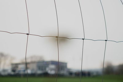 Close-up of white fence against sky