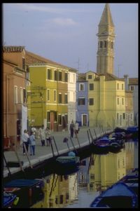 Boats in canal amidst buildings in city