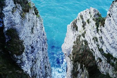 High angle view of sea by cliff