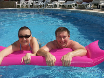 Portrait of a smiling young man swimming pool