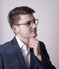 Close-up portrait of young man against white background