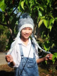 Portrait of smiling girl holding plants