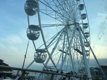 Low angle view of ferris wheel against sky