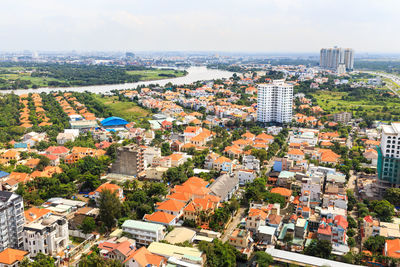 High angle view of buildings in city against sky on sunny day