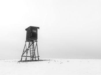 Traditional windmill on field against sky