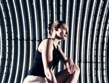 Woman kneeling against wall