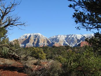 Scenic view of mountains against clear blue sky