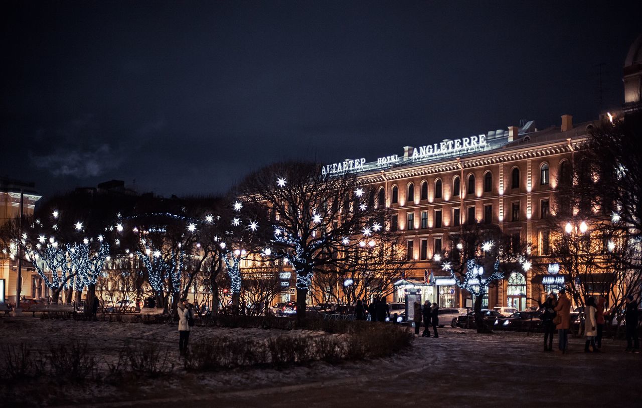 illuminated, night, building exterior, architecture, built structure, sky, city, lighting equipment, street light, street, city life, dusk, residential structure, outdoors, light - natural phenomenon, residential building, road, cityscape, residential district, incidental people