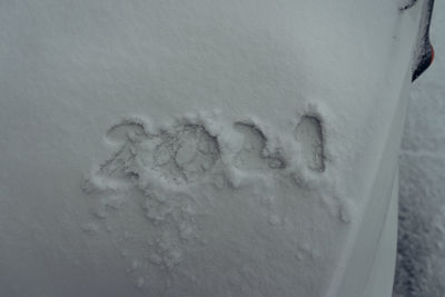 Close-up of footprints on snow covered wall