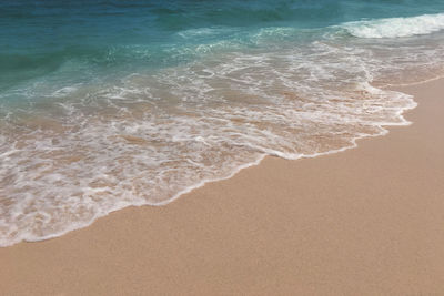 High angle view of waves rushing towards shore