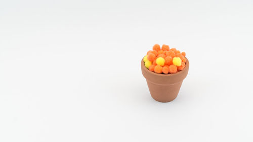 Close-up of orange slice over white background