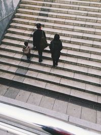 Rear view of man walking up stairs