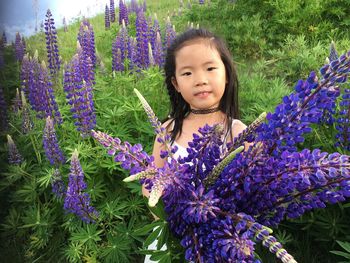 Portrait of girl on purple flowering plants