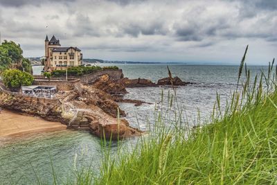 Panoramic view of sea and buildings against sky