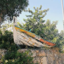 Boat moored in water against sky