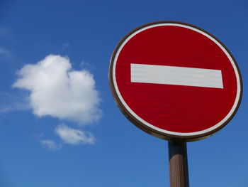 Low angle view of do not enter sign against sky