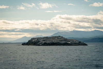 Scenic view of sea and mountains against sky