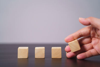 Close-up of hand holding toy on table