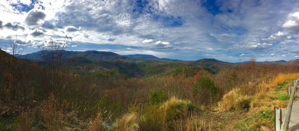 Countryside landscape against cloudy sky