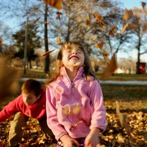 Close-up of cute girl against trees