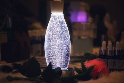 Close-up of purple flower on glass table