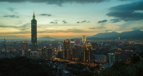 Cityscape with taipei 101 against sky during sunset