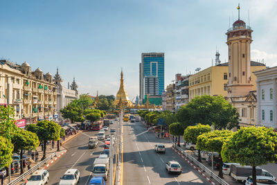 Panoramic view of city street and buildings against sky