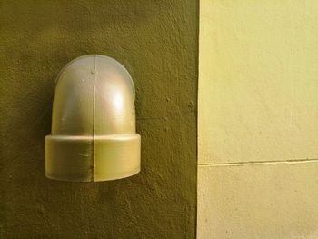 Close-up of electric lamp on wall