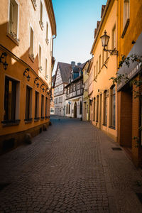 Empty alley amidst buildings in city